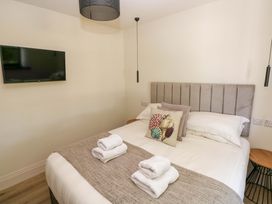 A bedroom with a bed and television at Just A Cottage in St Florence