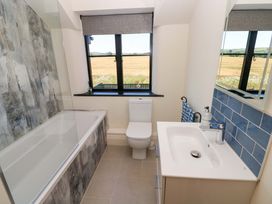 A bathroom with a bathtub, toilet, and sink at Just A Cottage in St Florence