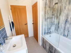 A bathroom with a bath and shower at Just A Cottage in St Florence