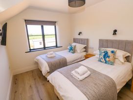 A bedroom with two single beds and a window at Just A Cottage in St Florence