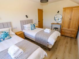 A bedroom with two single beds and a dresser at Just A Cottage St Florence