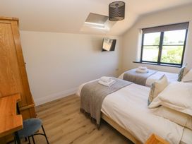 A bedroom with two beds and a television at Just A Cottage in St Florence