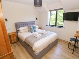 A bedroom with a bed and television at Just A Cottage in St Florence