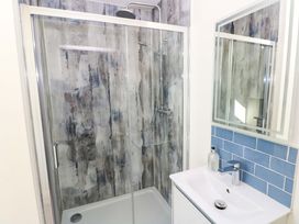 A bathroom with a shower and sink at Just A Cottage St Florence