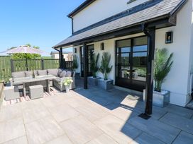 A patio with outdoor seating and table at Just A Cottage in St Florence