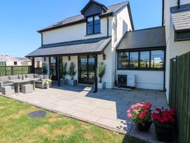 A garden with patio furniture and plants at Just A Cottage St Florence