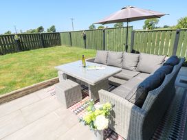 An outdoor seating area with a sofa and table at Just A Cottage St Florence