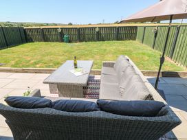 A garden with a sofa and coffee table at Just A Cottage St Florence