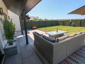 An outdoor seating area with a sofa and coffee table at Just A Cottage in St Florence