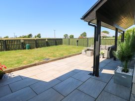 A garden patio area with outdoor furniture at Just A Cottage St Florence