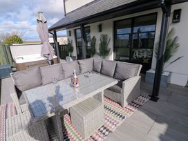 An outdoor patio with a sofa and table at Just A Cottage in St Florence