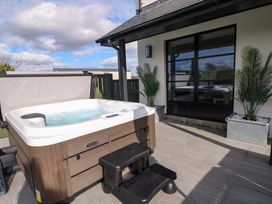 An outdoor area with a hot tub and steps at Just A Cottage in St Florence
