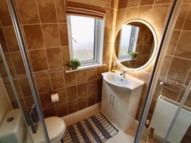A bathroom with a sink and toilet at Lowena Lodge Whitsand Bay Holiday Park near Millbrook
