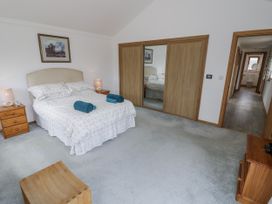 A bedroom with a bed and nightstand at Owl Barn in Banbury