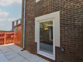 An exterior view showing a window and an orange door at 3 Longstone Park Beadnell