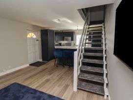 A living room with stairs leading to the upper level at 3 Longstone Park Beadnell