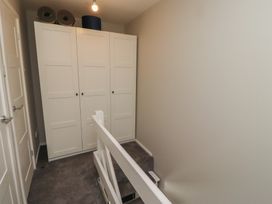 A landing area with a wardrobe and stairs at 3 Longstone Park Beadnell