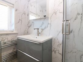 A bathroom with a sink and shower at Seaspray in Beadnell