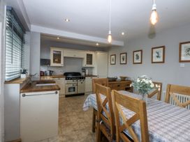 A kitchen with a sink and stove at 1 Maes Y Ffynnon Llandegfan