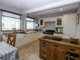 A kitchen with cabinets and countertop at 1 Maes Y Ffynnon Llandegfan
