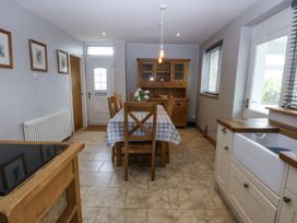 A dining room with a table and chairs at 1 Maes Y Ffynnon Llandegfan
