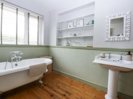 A bathroom with a bathtub and sink at 1 Maes Y Ffynnon in Llandegfan