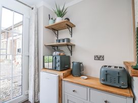 A kitchen with a kettle and toaster at Firefly Cottage