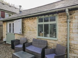 An outdoor seating area with chairs and a table at Firefly Cottage
