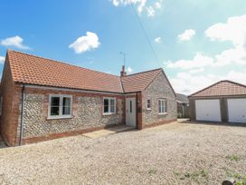 A house with a garage and front yard at Woodlark in 