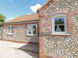 A house with a pathway and windows at Woodlark