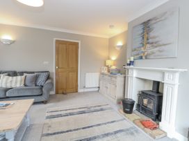 A living room with a sofa and fireplace at Woodlark