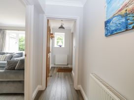 A hallway with a couch and windows at Woodlark