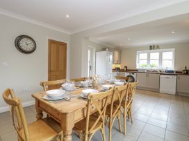 A kitchen with a dining table and chairs at Woodlark