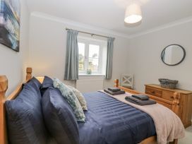 A bedroom with a bed and window at Woodlark