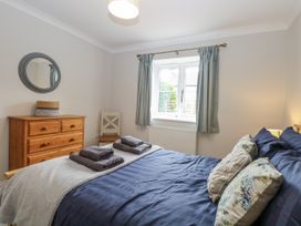 A bedroom with a bed and dresser at Woodlark