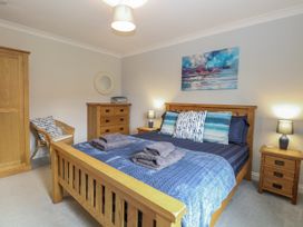 A bedroom with a bed and chest of drawers at Woodlark
