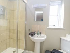 A bathroom with a shower, sink, and toilet at Woodlark