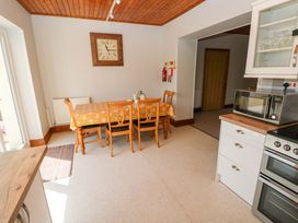 A kitchen with a dining table and chairs at The Sycamores in Llawhaden near Narberth