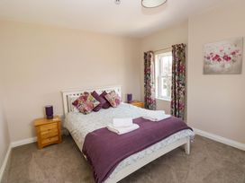 A bedroom with a bed and bedside table at The Sycamores Llawhaden near Narberth