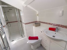A bathroom with a shower, toilet, and sink at The Sycamores in Llawhaden near Narberth
