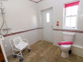 A bathroom with a shower and wheelchair at The Sycamores in Llawhaden near Narberth