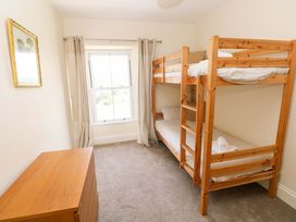 A bedroom with a bunk bed and dresser at The Sycamores Llawhaden near Narberth