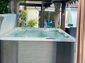 A hot tub with water in an outdoor area at 8 Church Road Ferndown