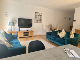 A living room with a television and sofas at 8 Church Road Ferndown