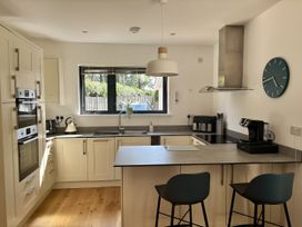 A kitchen with modern appliances and a large window at 8 Church Road Ferndown