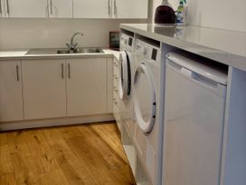 A laundry room with sink and appliances at 8 Church Road Ferndown