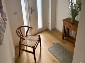 A hallway with a chair and table at 8 Church Road, Ferndown