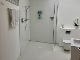 A bathroom with a shower and sink at 8 Church Road Ferndown