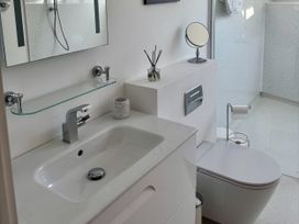 A bathroom with a sink and toilet at 8 Church Road, Ferndown