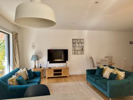 A living room with sofas and a television at 8 Church Road Ferndown